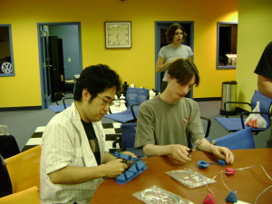 Takaaki (left) and Jimmy (right) are cutting out parts for the sensor bar