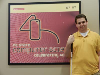 Picture of Sean Mealin standing next to the NC State Computer Science sign